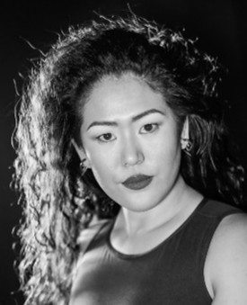 Black-and-white headshot of Elle Shiga